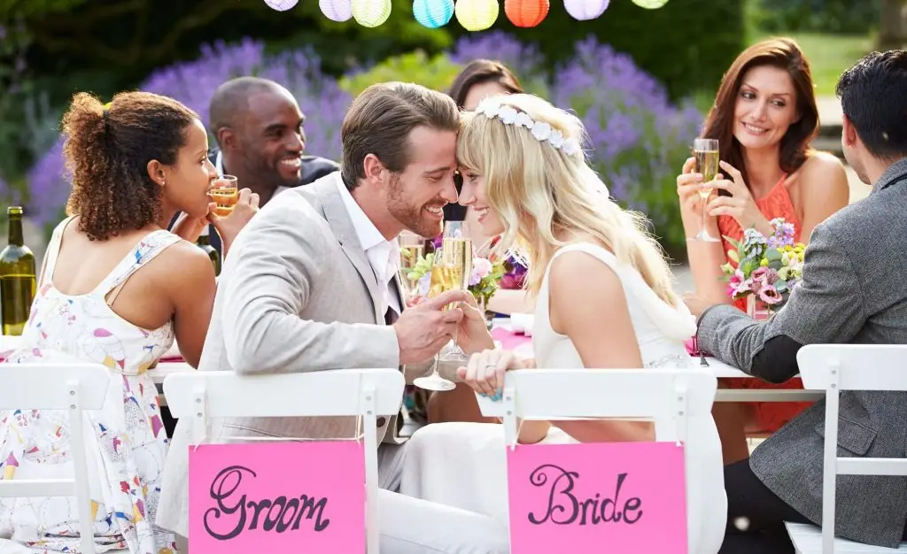 Bride and groom sharing a drink at their wedding