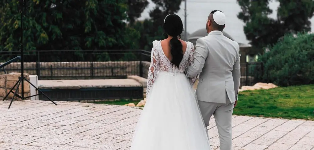 Newly married couple walks arm-in-arm