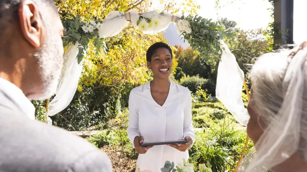 A marriage officiant talks to a couple