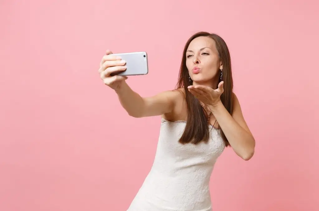 Woman blowing a kiss on a video call
