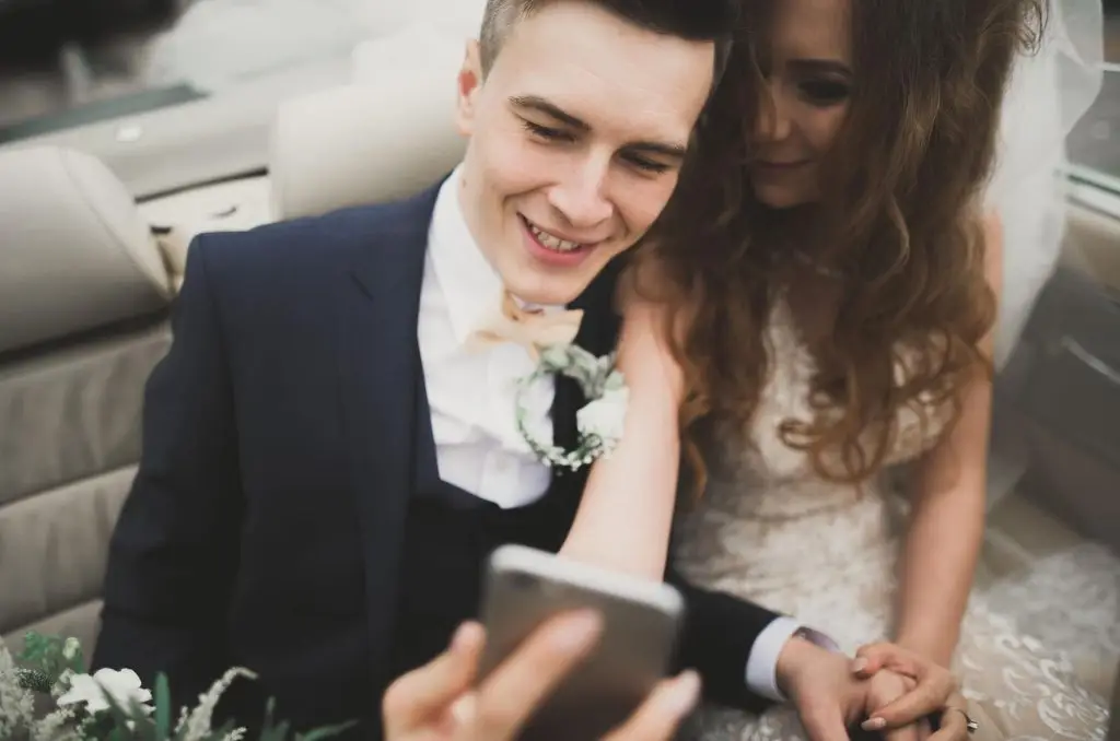Couple smiles during their online wedding ceremony