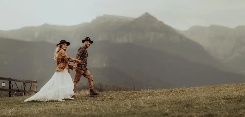 Couple walking in the scenic mountains after getting married